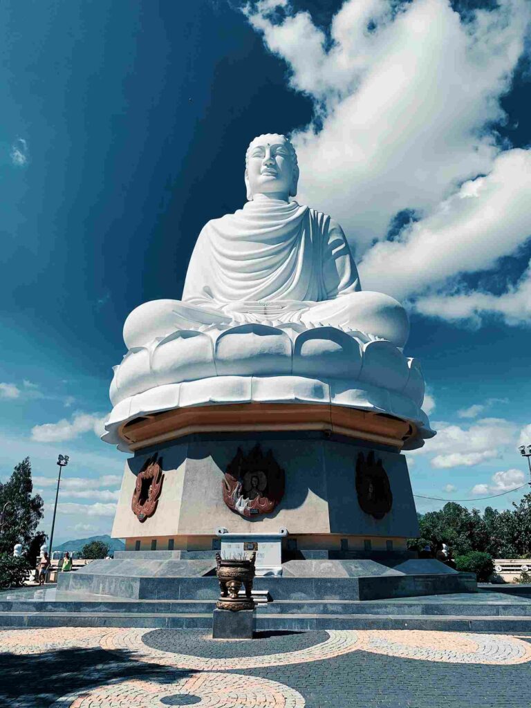 The white Gautama Buddha nestled on a lotus leaf at Long Son Pagoda complex