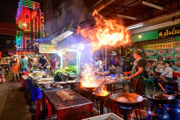 Night street food in Thailand, chef cooking outside