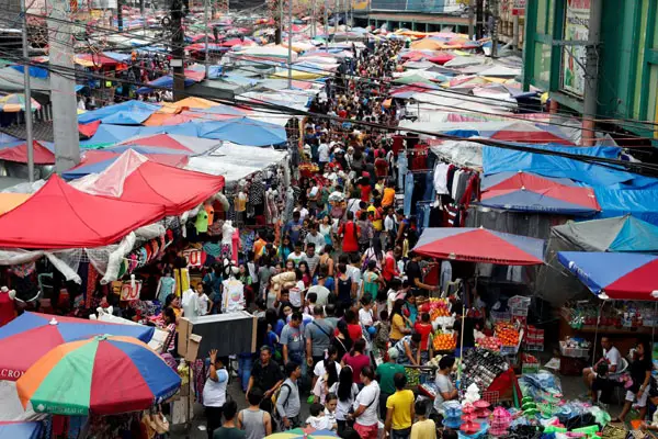 People shop at a street market in Divisoria, Manila